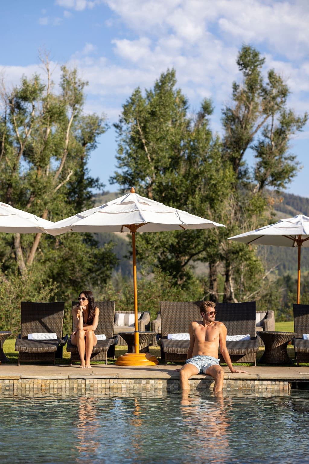 Couple Sitting By The Pool In Jackson Hole