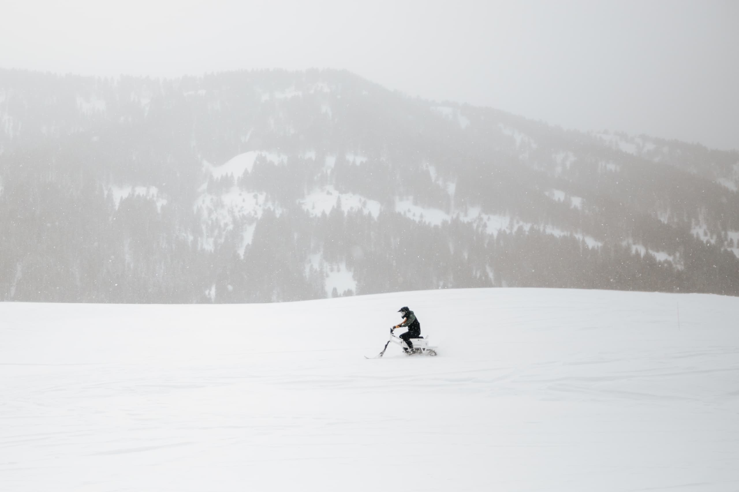 A person moonbiking through the snow in Jackson Hole, WY