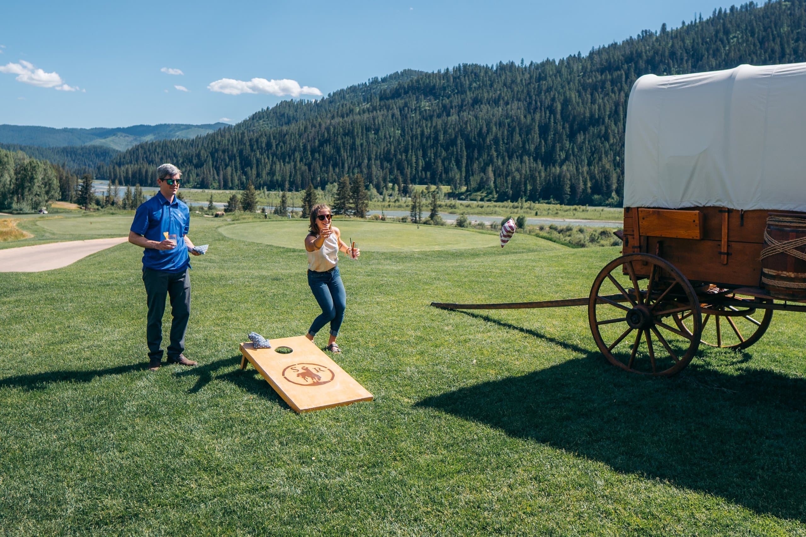two people playing a beanbag toss