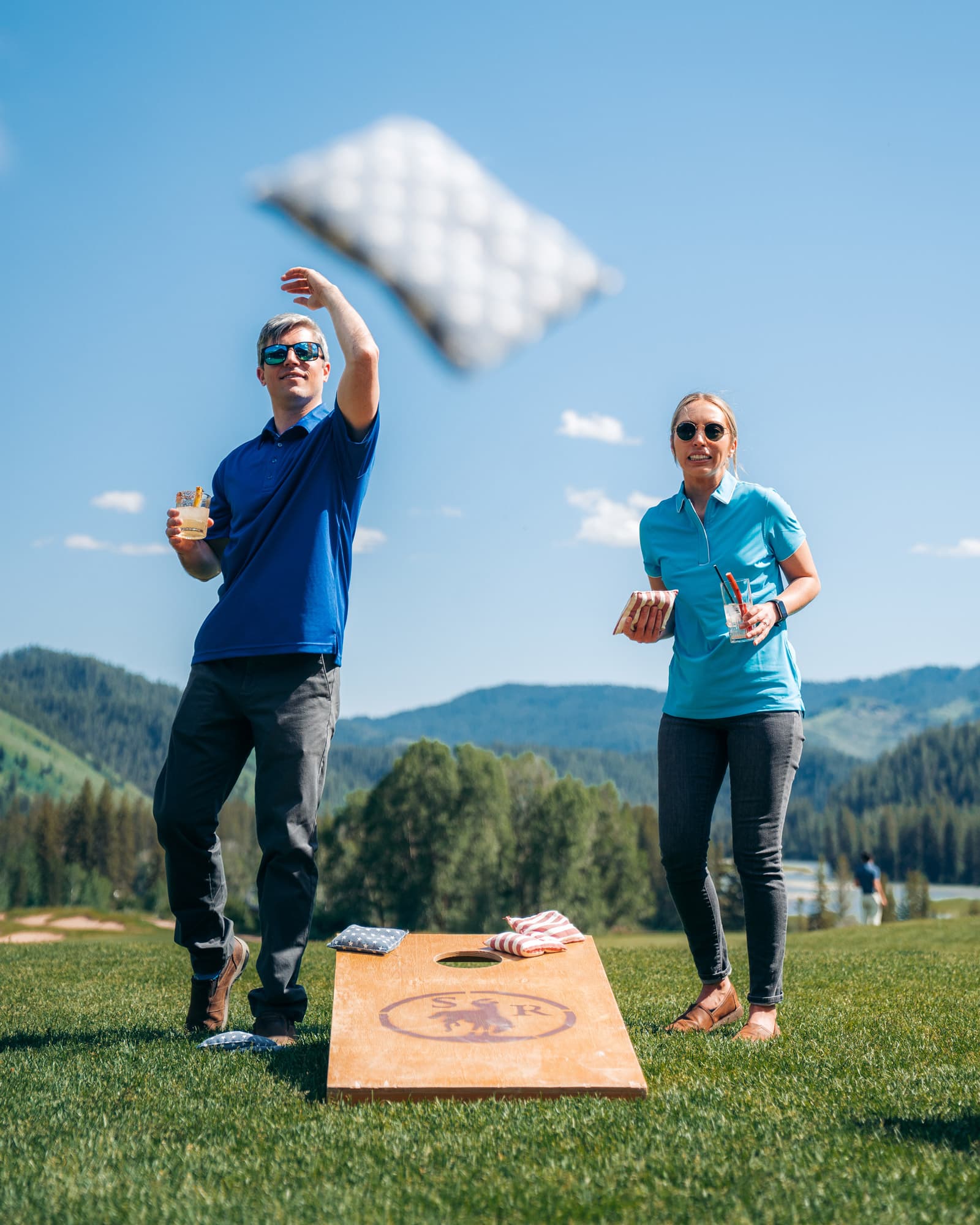 couple playing sand bag game