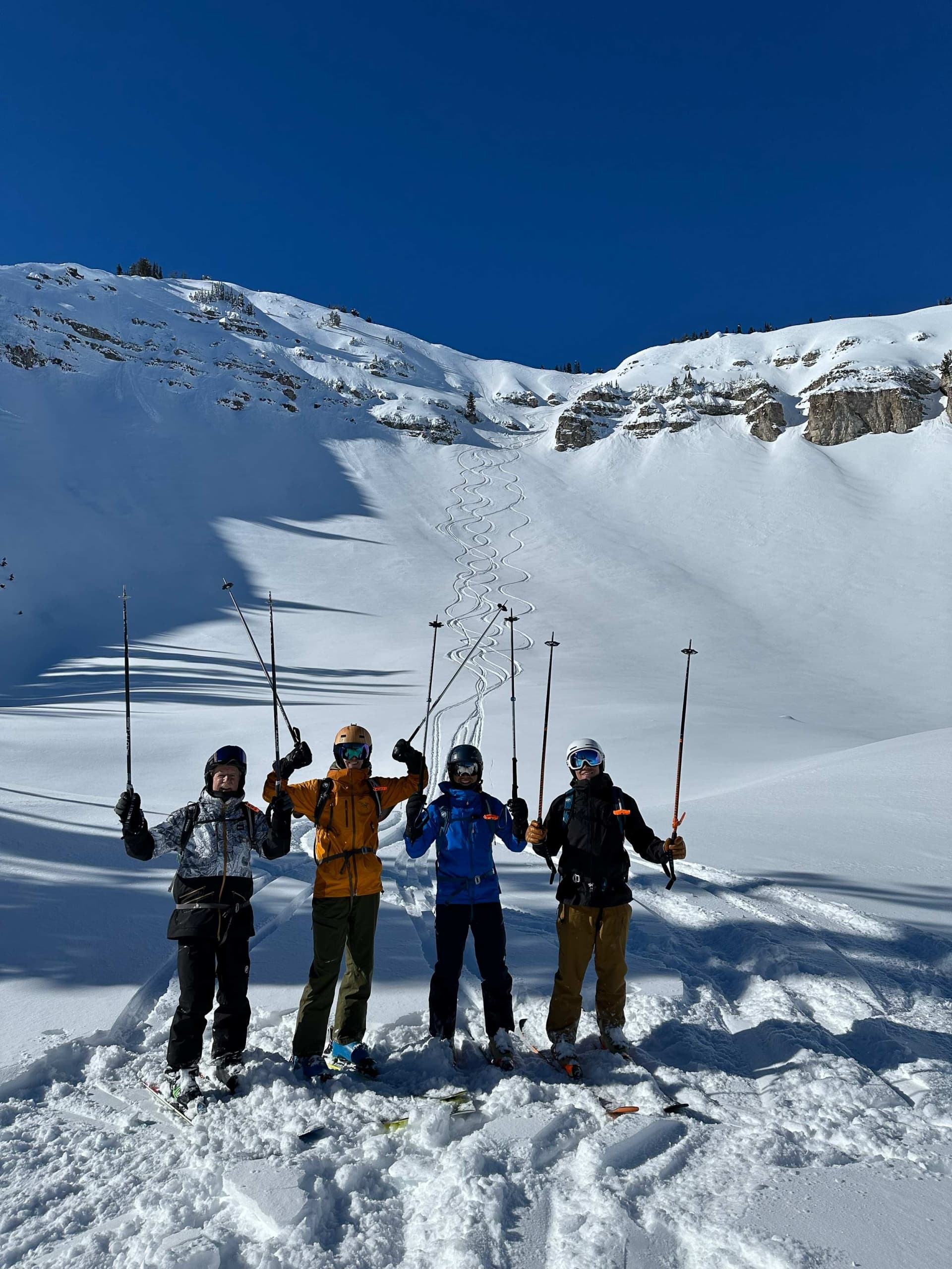 Heli Skiers At The Bottom Of The Mountain