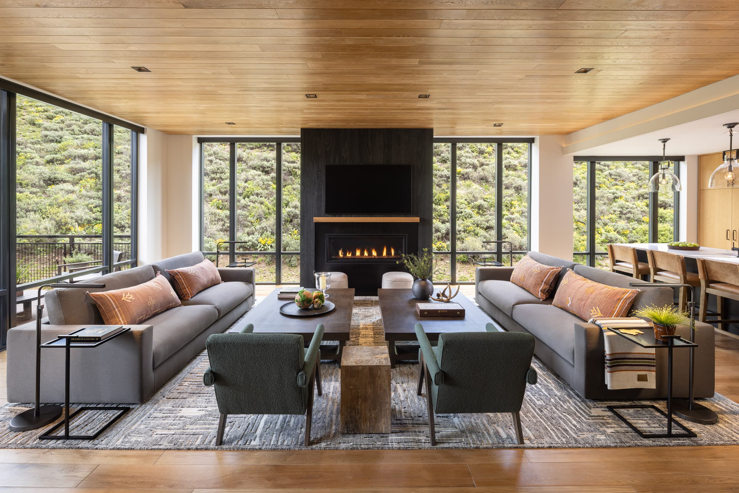 Interior shot of the open living space with nature views from the Penthouse in the Sylvan Lodge at Snake River Sporting Club.