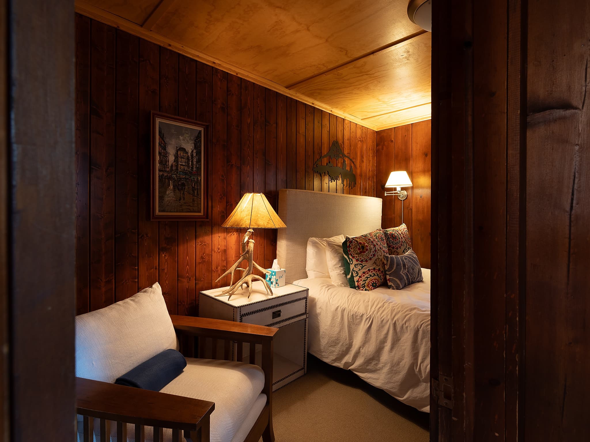 Intimate cabin bedroom retreat with western decor at Snake River Sporting Club in Jackson Hole