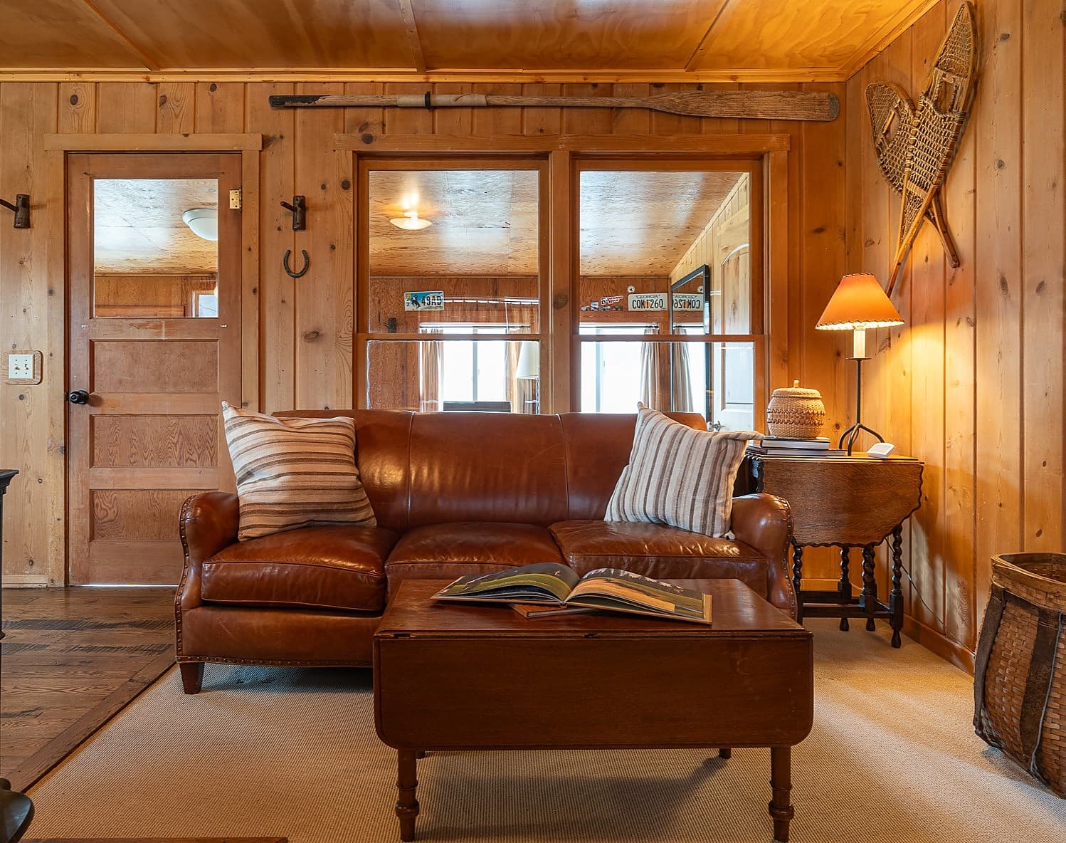 Cozy leather sofa in a rustic hunting and fishing cabin living room at Snake River Sporting Club in Jackson Hole, Wyoming