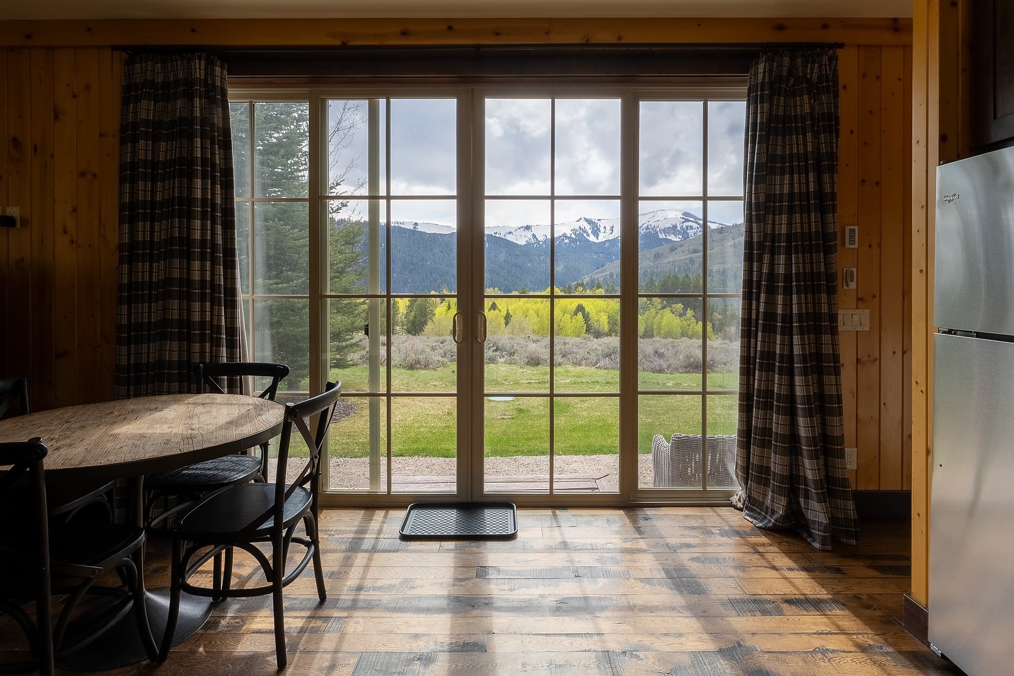 Snowcapped mountain views from a cabin dining area at Snake River Sporting Club
