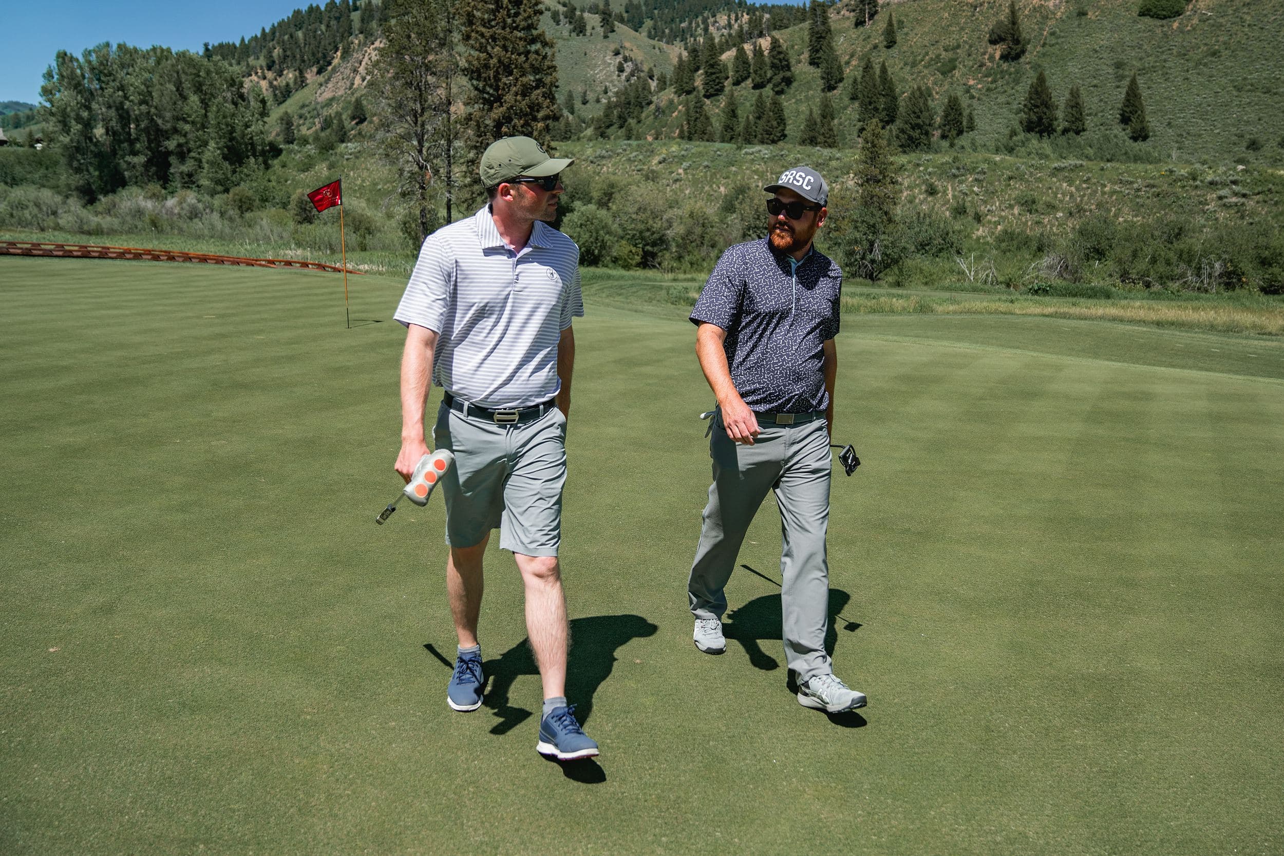 Two golfers walking the green at Snake River Sporting Club in Jackson Hole, Wyoming