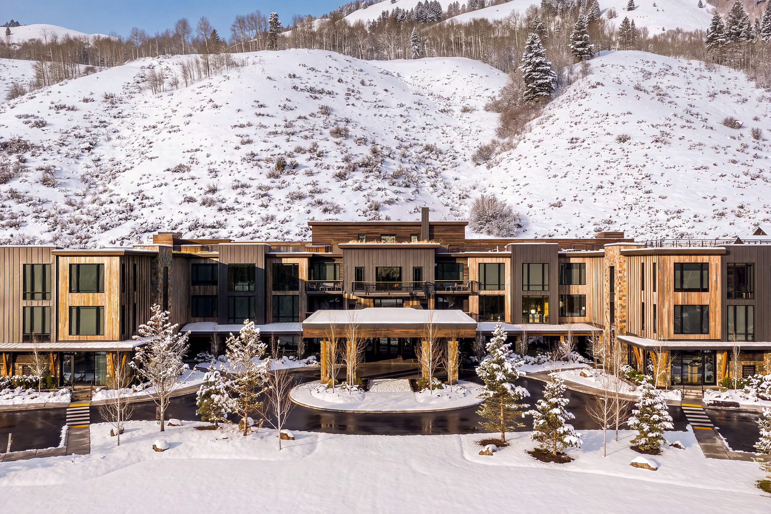 Aerial winter view of Sylvan Lodge with snow-covered hillside at Snake River Sporting Club in Jackson Hole, Wyoming