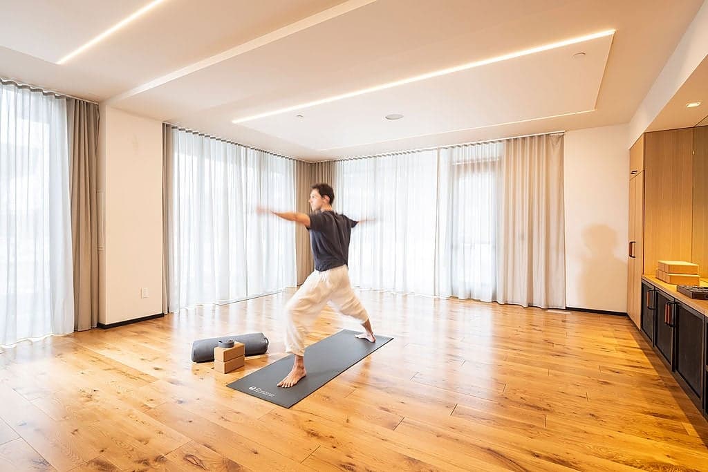 Guest practicing yoga in the Sylvan Lodge wellness studio at Snake River Sporting Club in Jackson Hole, Wyoming.
