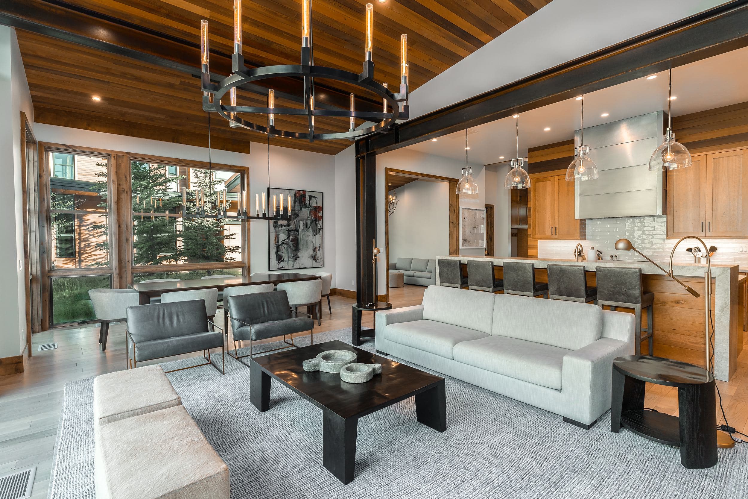 Open-concept living room with vaulted wood ceiling and mountain views at Snake River Sporting Club in Jackson Hole, Wyoming