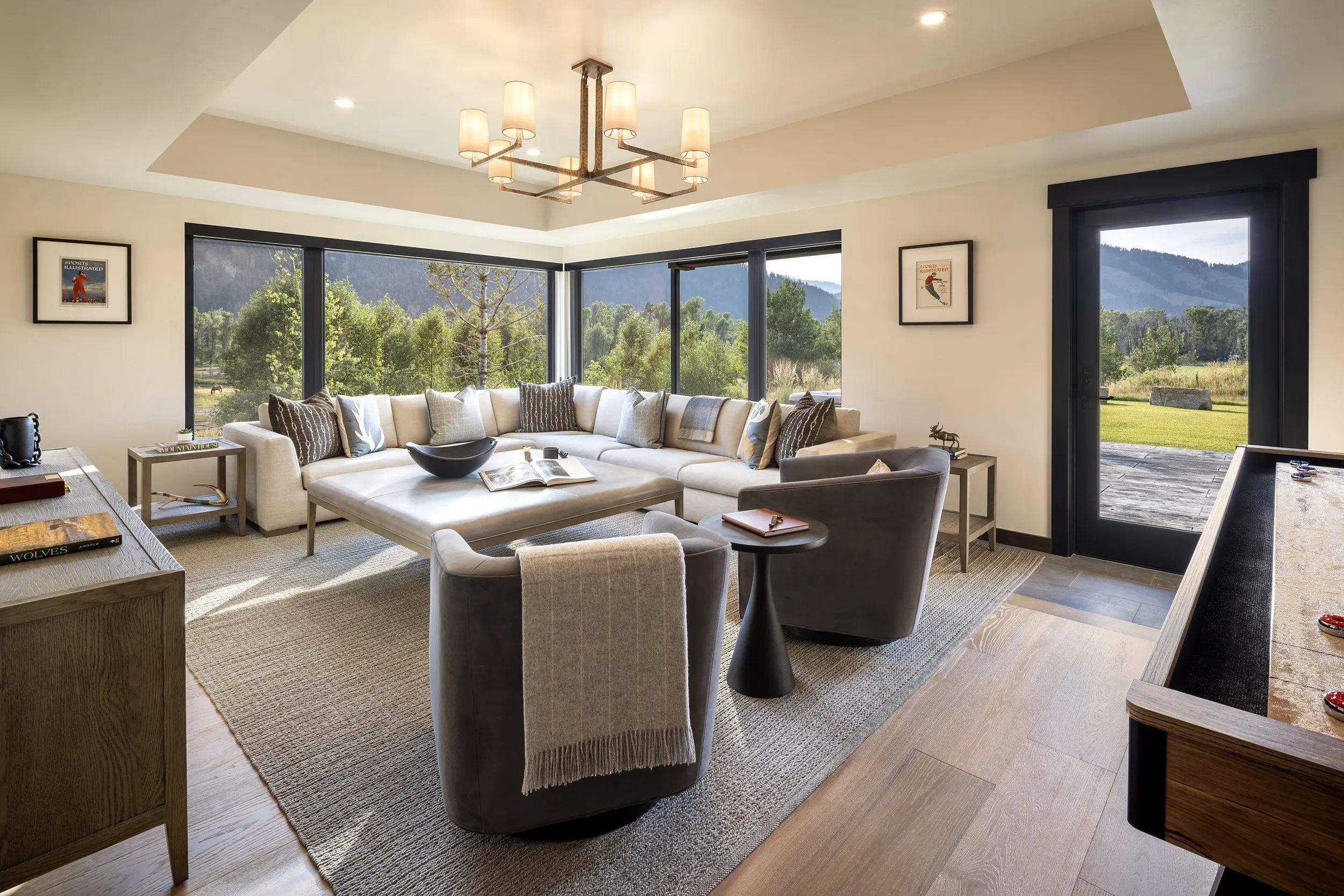 Lower level lounge with sectional seating and mountain views at Snake River Sporting Club in Jackson Hole, Wyoming