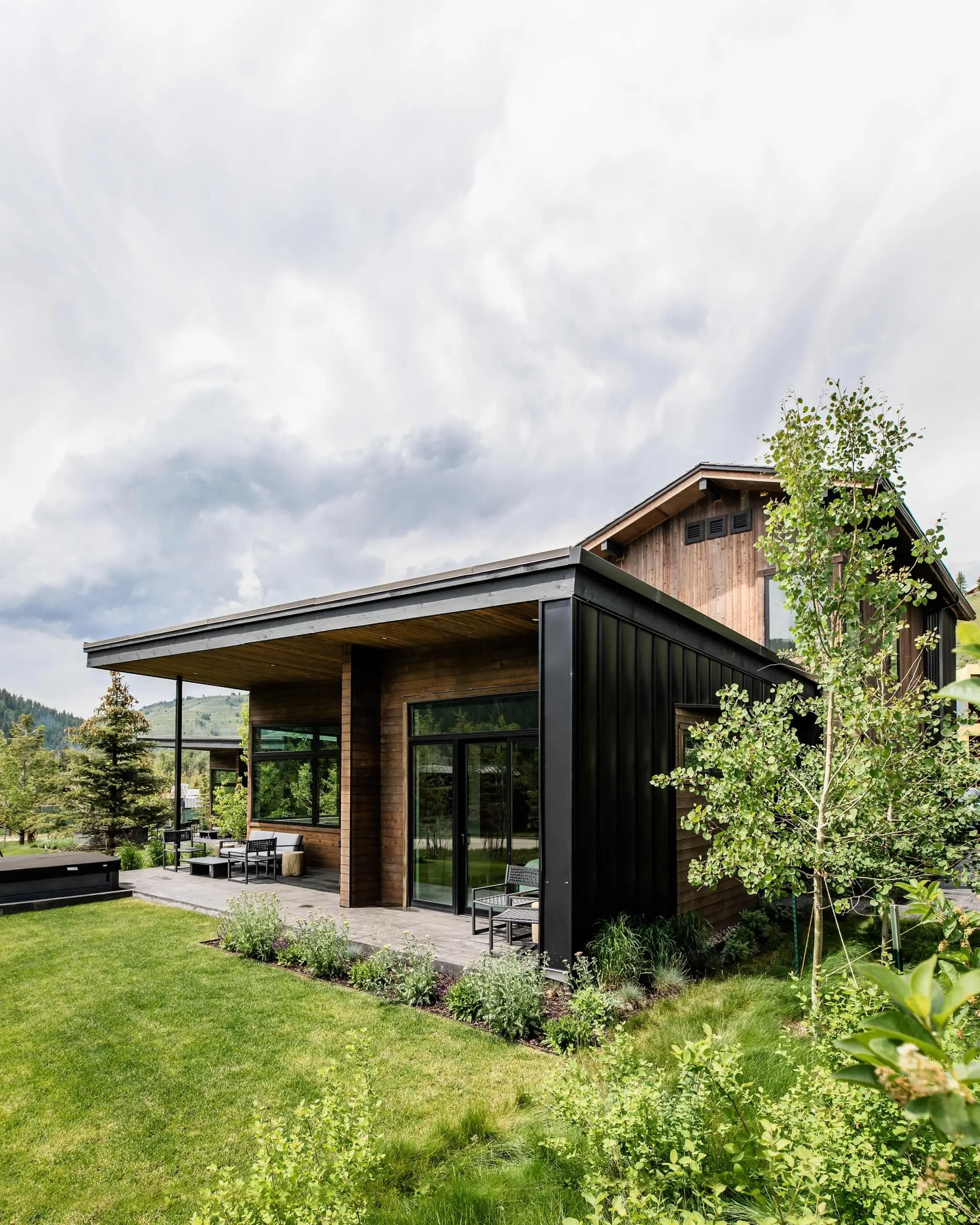 Meadow Cabin exterior surrounded by wildflowers at Snake River Sporting Club in Jackson Hole, Wyoming